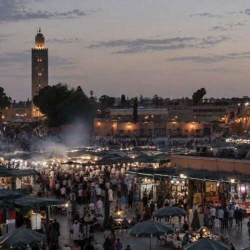 Jemaa el-Fna square at dusk, with the Koutoubia minaret in the background, Marrakech
