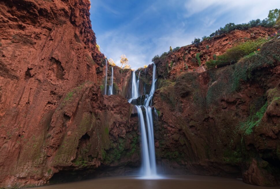 Ouzoud Waterfalls cascading over red cliffs in the Middle Atlas, the tallest and most-visited waterfall day trip from Marrakech