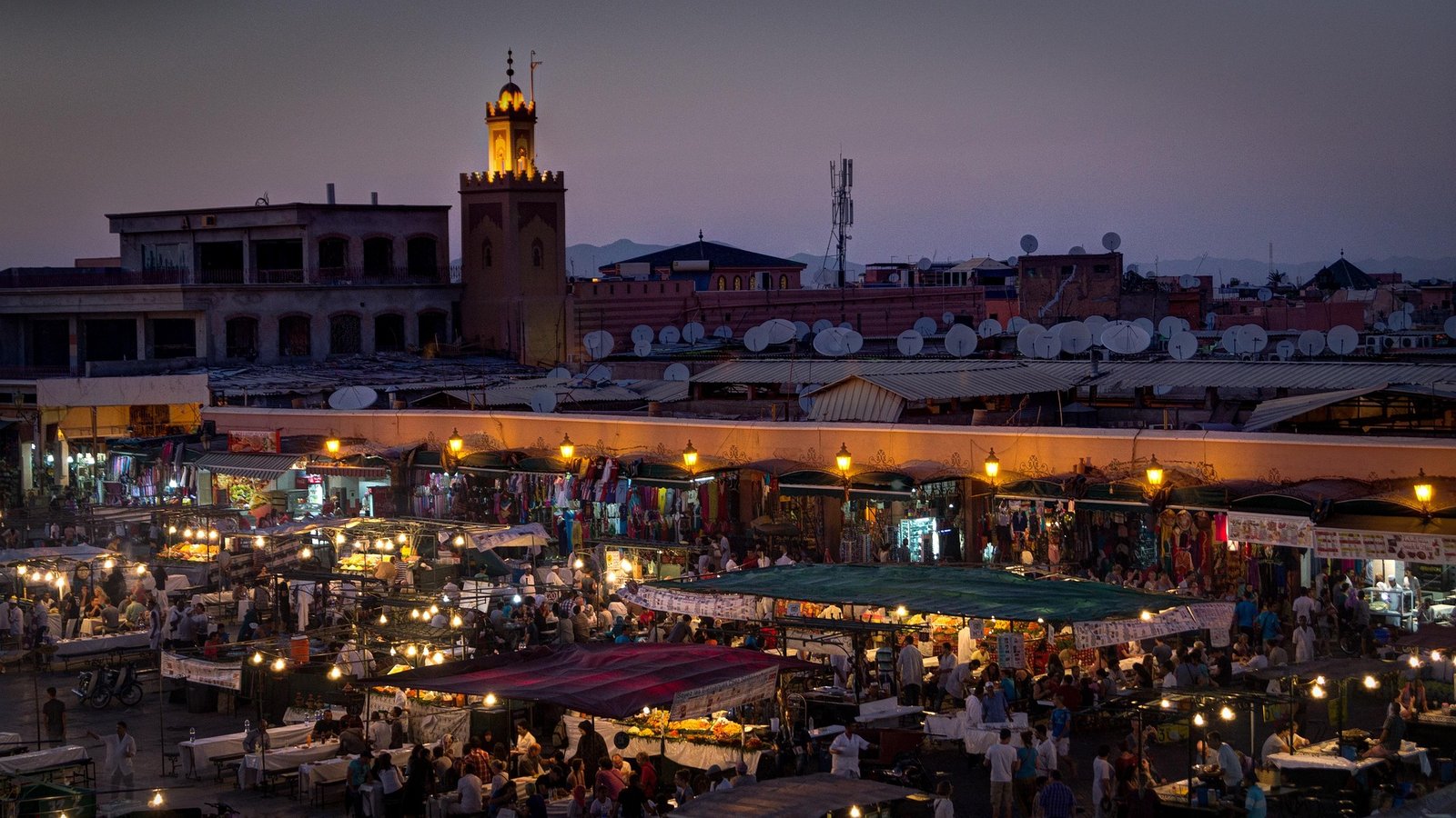Jemaa el-Fna square at dusk, with the Koutoubia minaret in the background, Marrakech