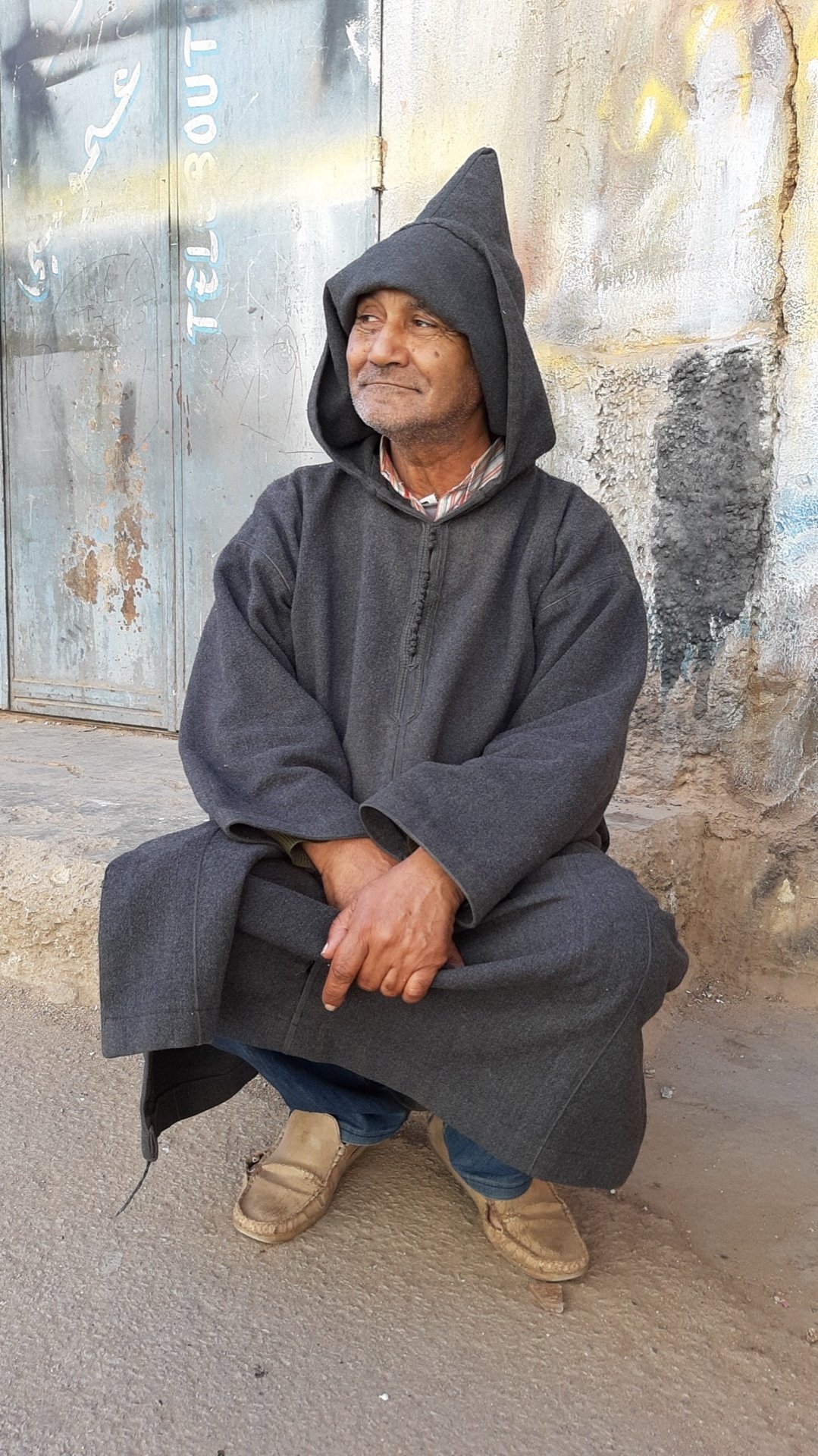 A traditional Moroccan djellaba, a long loose hooded robe worn by both men and women, available to buy as a souvenir but not required tourist attire