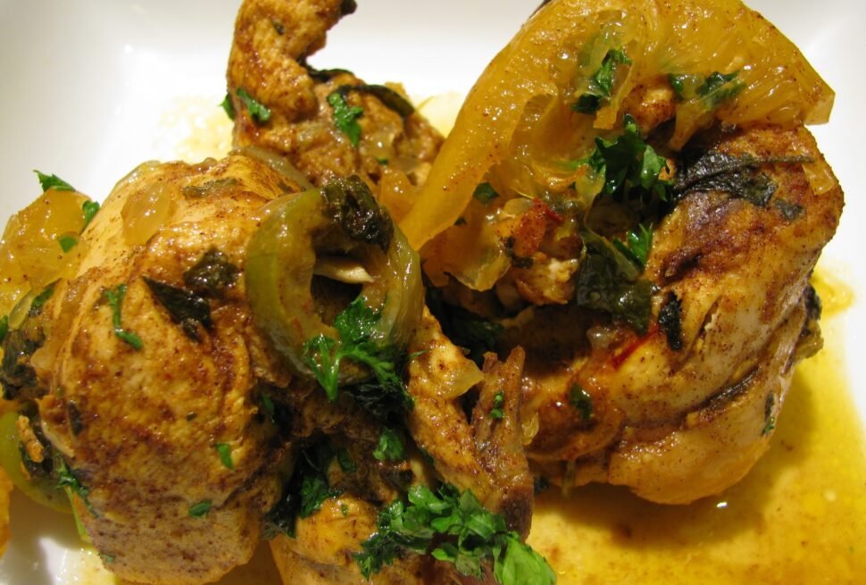 Moroccan chicken tagine simmered with preserved lemons, green olives, and saffron, served in a traditional clay tagine pot
