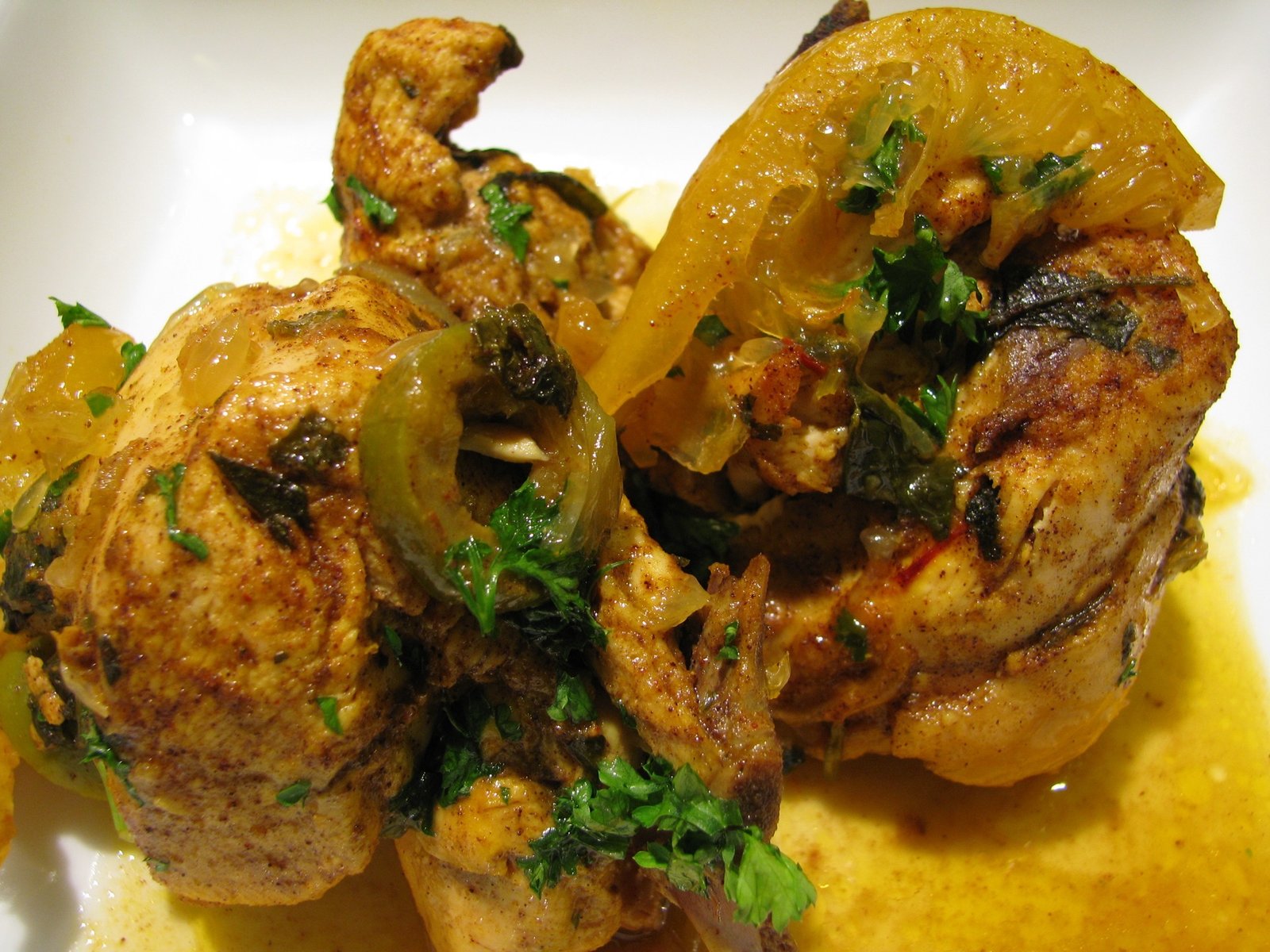 Moroccan chicken tagine simmered with preserved lemons, green olives, and saffron, served in a traditional clay tagine pot