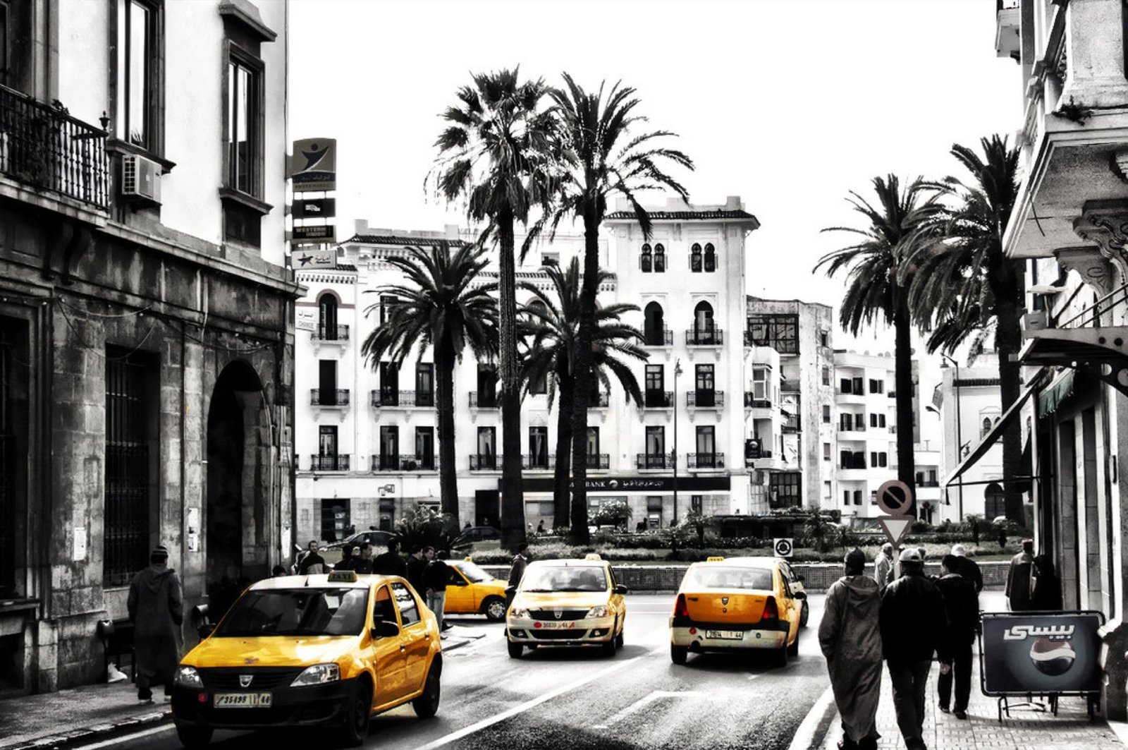 Small yellow petit taxis parked at the center of Tetouan, Morocco, the standard short-distance taxi used within Moroccan cities