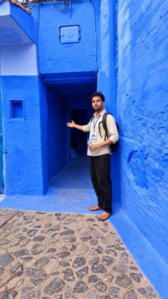 Azzdine Yakoubi, a Viajar Para Marrocos guide, in a blue alley of Chefchaouen, Morocco